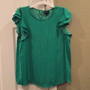 Green blouse. Feels silky.